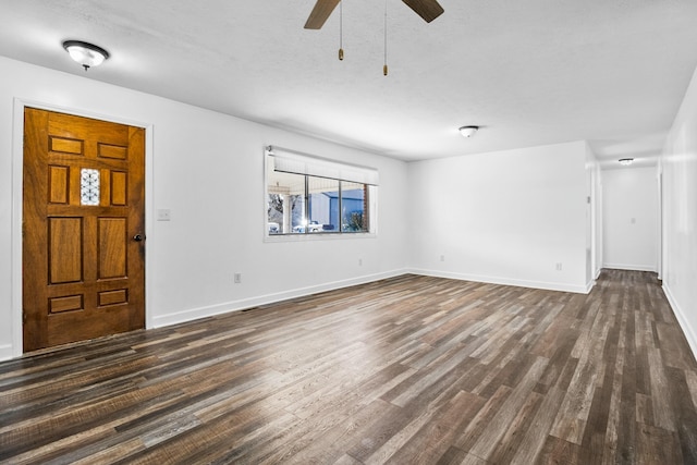 unfurnished living room with a textured ceiling, dark wood-type flooring, and ceiling fan