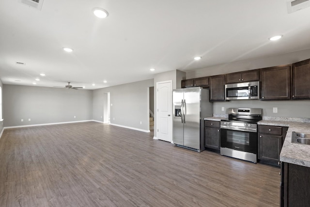 kitchen featuring dark hardwood / wood-style flooring, stainless steel appliances, ceiling fan, and dark brown cabinetry