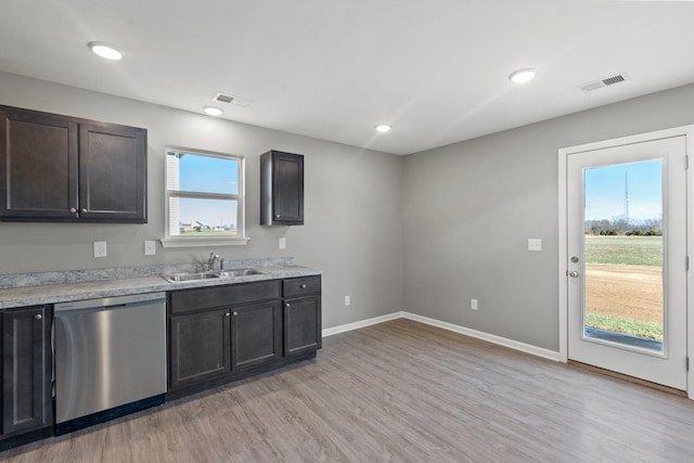 kitchen with sink, a wealth of natural light, light hardwood / wood-style floors, and dishwasher