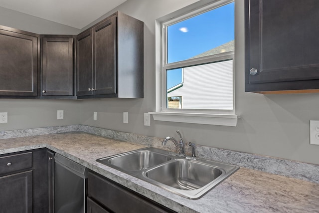 kitchen featuring dark brown cabinetry, sink, and dishwasher