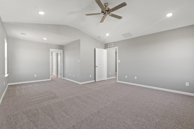 spare room featuring vaulted ceiling, ceiling fan, and carpet