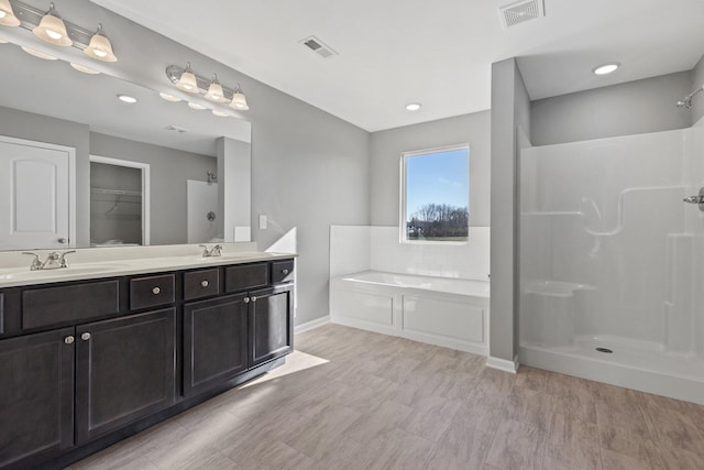 bathroom with vanity and a tub