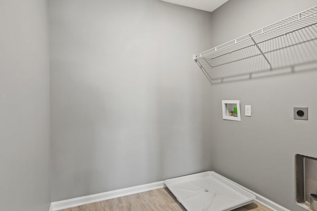 washroom with hardwood / wood-style flooring, washer hookup, and hookup for an electric dryer