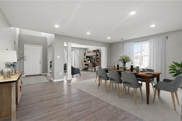 dining room featuring decorative columns and hardwood / wood-style floors