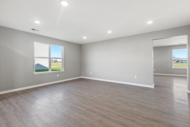 unfurnished room with dark wood-type flooring