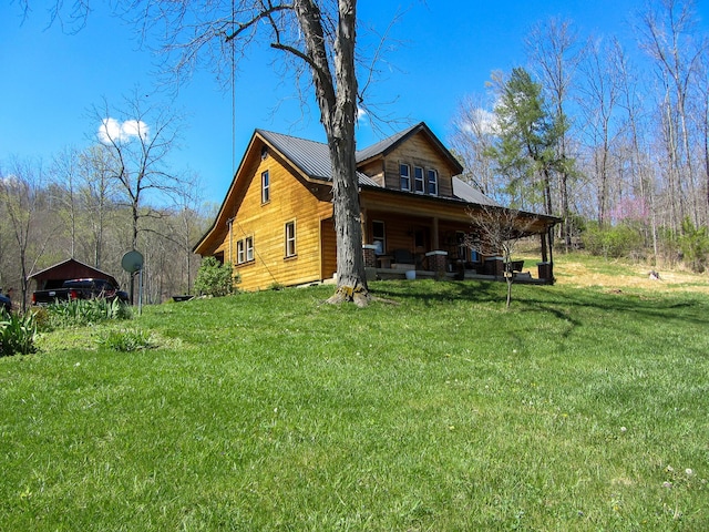 exterior space featuring a yard and covered porch