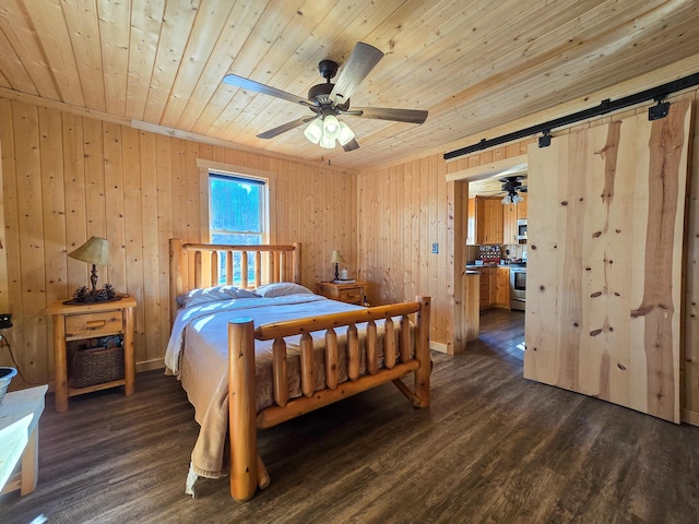 bedroom with ceiling fan, dark hardwood / wood-style floors, and wooden ceiling