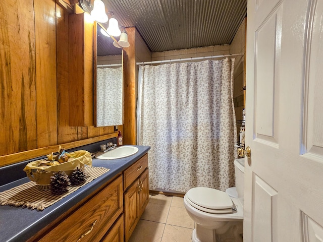 bathroom with tile patterned flooring, vanity, curtained shower, and toilet