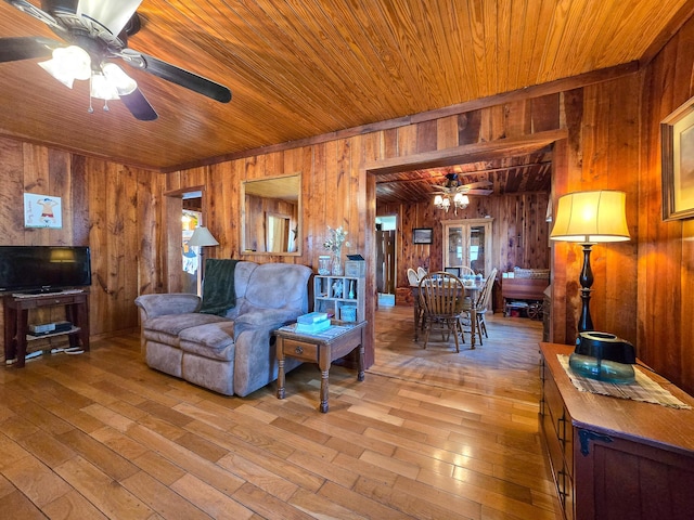 living room with wood walls, wooden ceiling, ceiling fan, and light hardwood / wood-style flooring