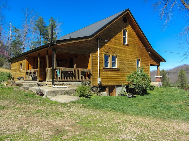 back of house with a yard and covered porch