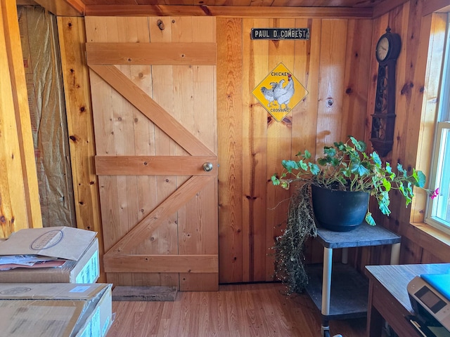 interior details with hardwood / wood-style flooring and wood walls