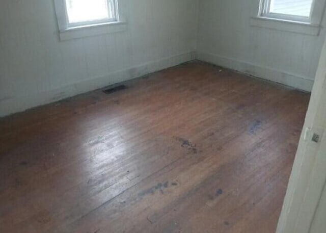 spare room with dark hardwood / wood-style floors