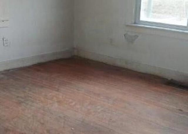 unfurnished room with hardwood / wood-style floors