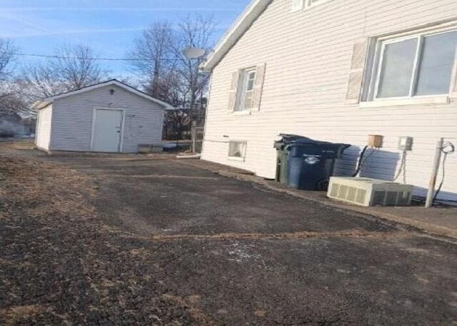 view of side of home with a storage unit