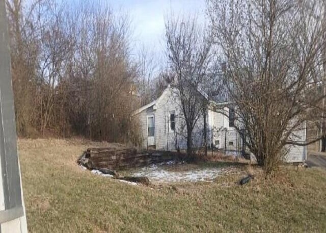 view of property exterior featuring a lawn