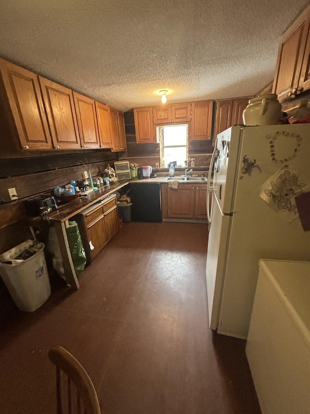 kitchen with white fridge and a textured ceiling