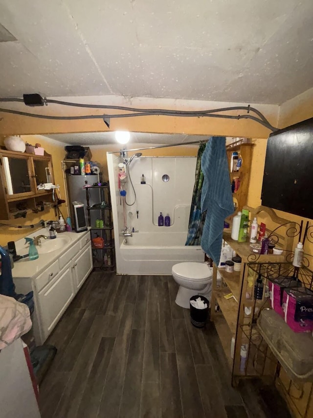 full bathroom with shower / tub combo with curtain, wood-type flooring, toilet, and vanity