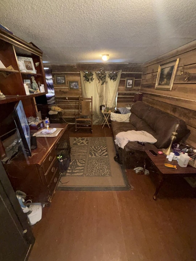 interior space featuring dark hardwood / wood-style flooring, wooden walls, and a textured ceiling