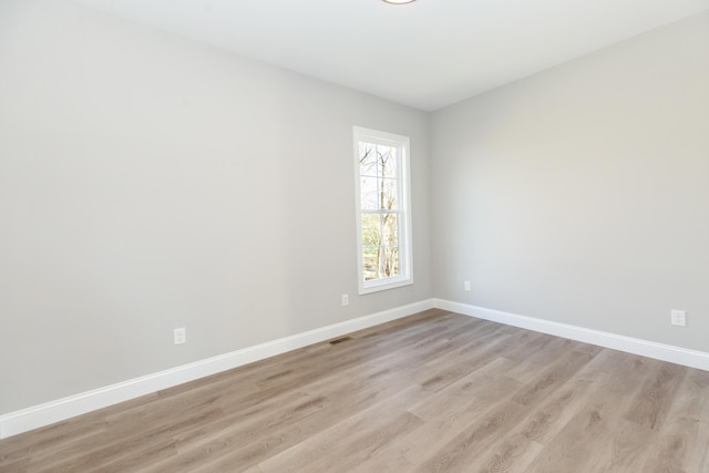 spare room with light wood-type flooring