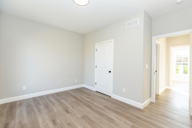 unfurnished room with light hardwood / wood-style flooring