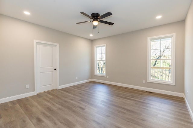 spare room with ceiling fan and hardwood / wood-style floors