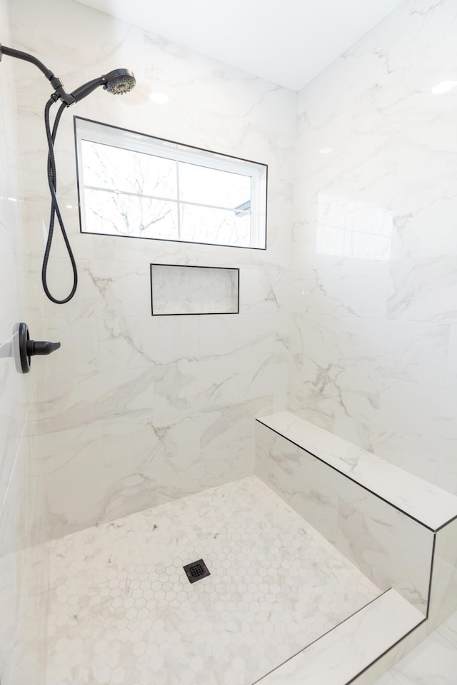 bathroom with tiled shower