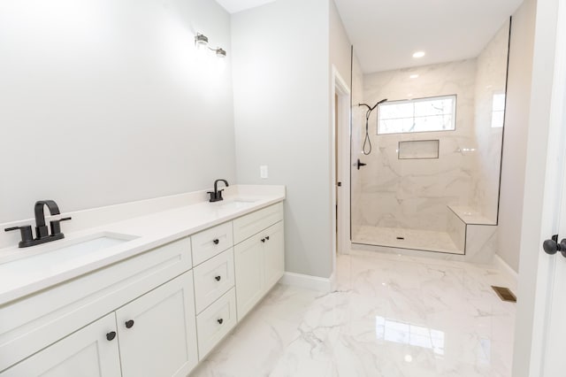 bathroom with vanity and a tile shower