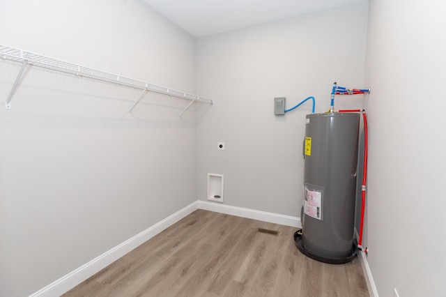 washroom with electric dryer hookup, light hardwood / wood-style flooring, and water heater