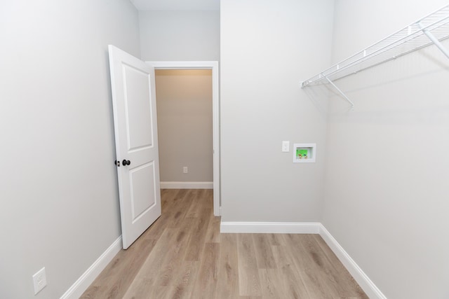 laundry area with hookup for a washing machine and light wood-type flooring