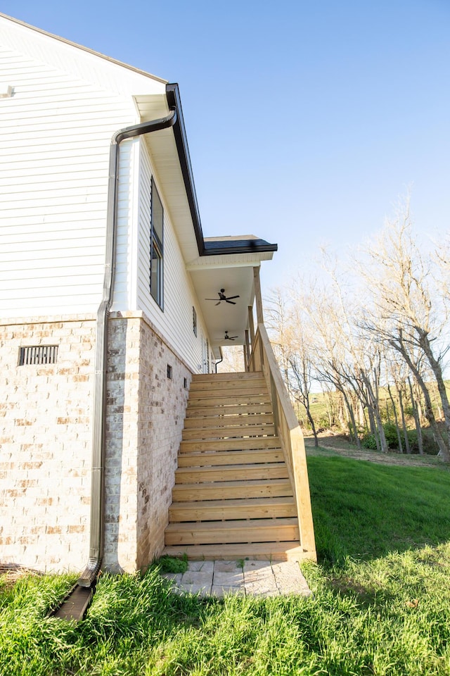 view of property exterior featuring a lawn and ceiling fan