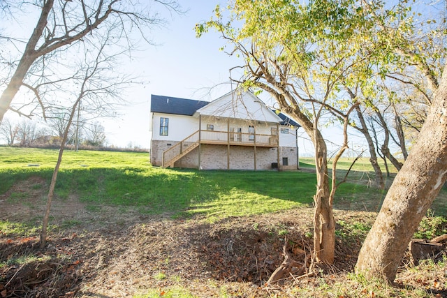 rear view of house featuring a lawn