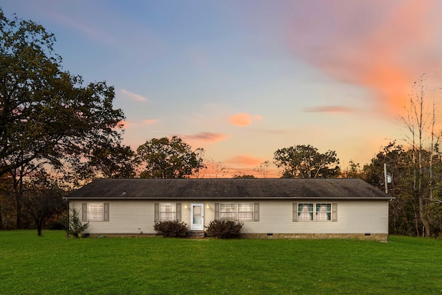 ranch-style home featuring a yard