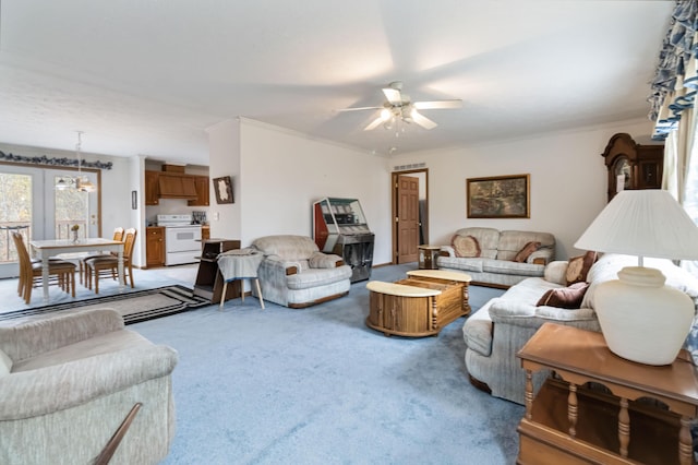 living room with ornamental molding, carpet floors, and ceiling fan