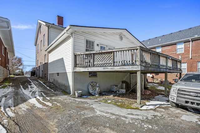 rear view of property featuring a deck