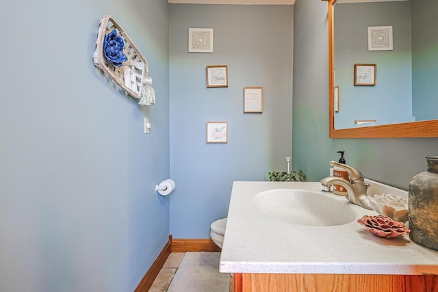 bathroom with vanity, tile patterned floors, and toilet