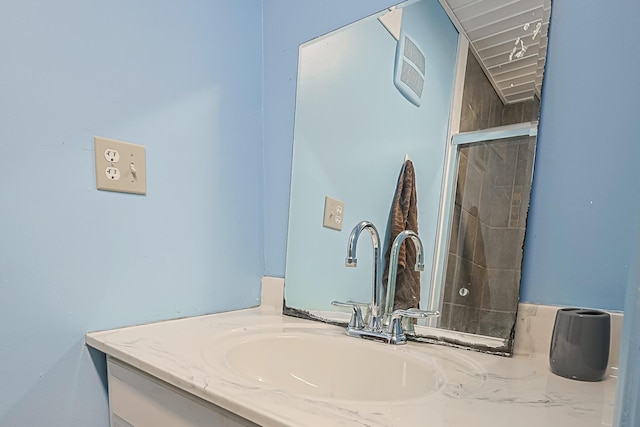 bathroom featuring vanity and a shower with shower door