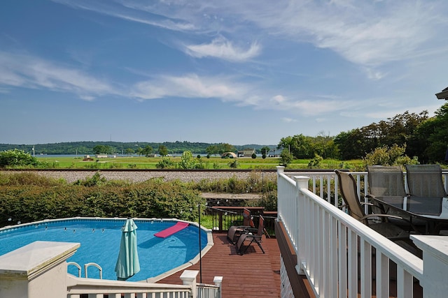 view of swimming pool featuring a wooden deck