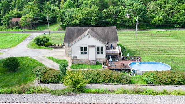 back of property featuring a swimming pool side deck