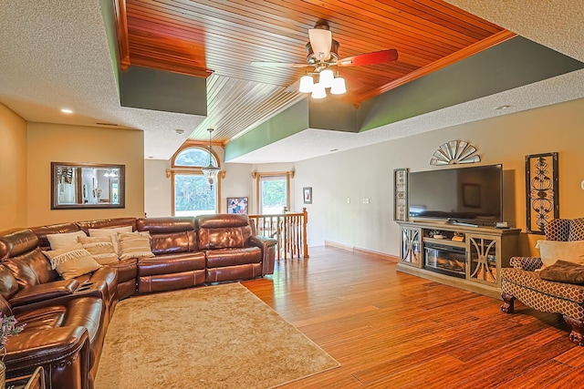 living room featuring hardwood / wood-style flooring, wooden ceiling, ceiling fan, and a textured ceiling