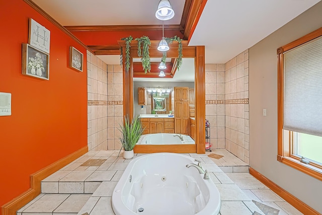 bathroom with ornamental molding, tiled bath, and vanity