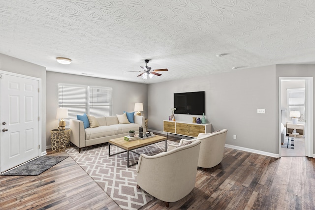 living room featuring hardwood / wood-style flooring, a textured ceiling, and ceiling fan