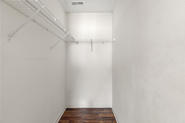 walk in closet featuring dark wood-type flooring