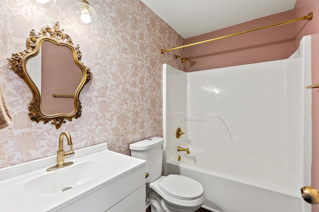 full bathroom featuring vanity, toilet, shower / washtub combination, and a textured ceiling