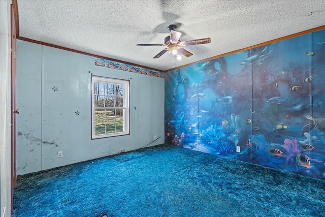 carpeted spare room with crown molding, ceiling fan, and a textured ceiling