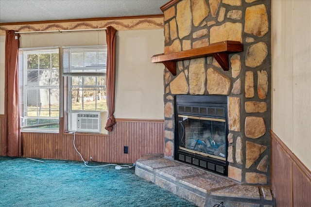 carpeted living room with cooling unit, a stone fireplace, wooden walls, and a textured ceiling