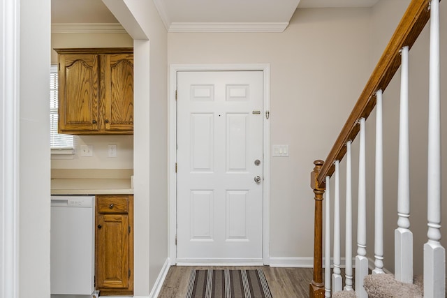 entryway with crown molding and wood-type flooring