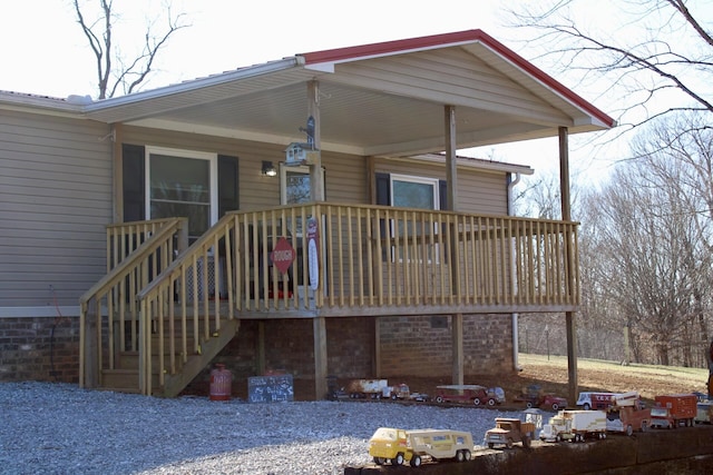 rear view of property featuring a porch