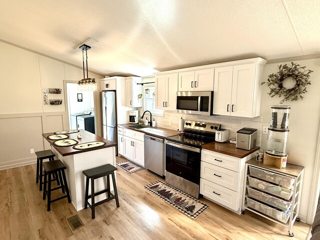 bathroom with vanity, hardwood / wood-style floors, a textured ceiling, and toilet