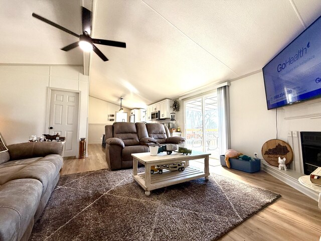 living room with hardwood / wood-style flooring and ceiling fan