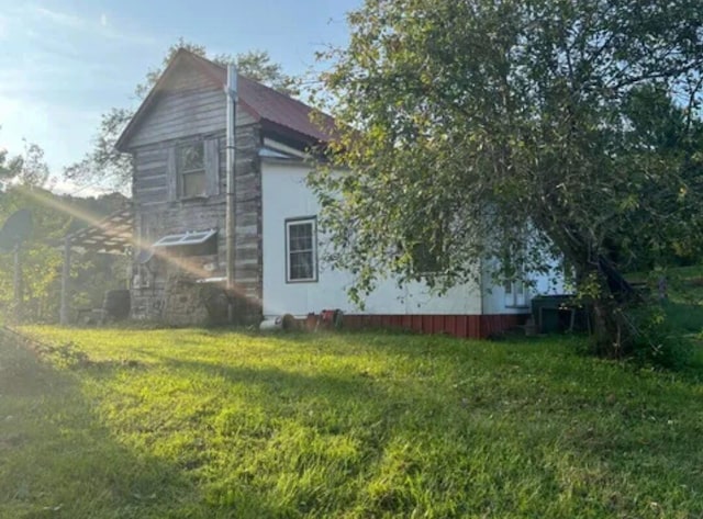 view of home's exterior with a yard